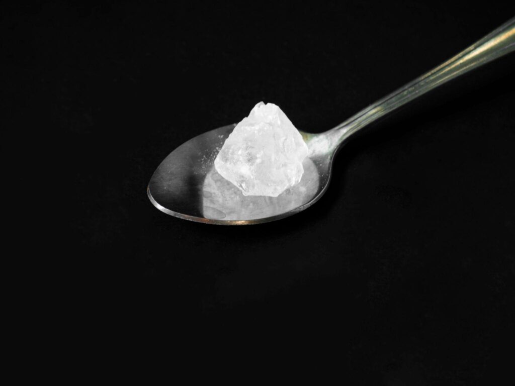 crack cocaine on old spoon with black background